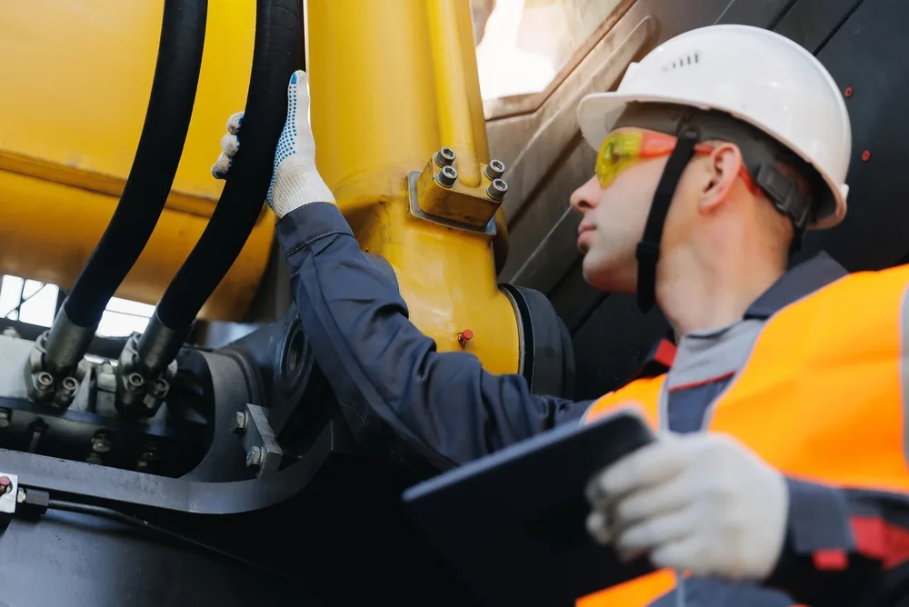 construction site inspector checks a machine