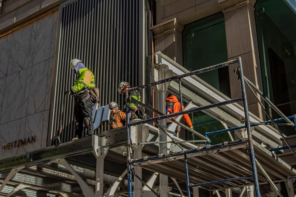Trabajadores de construcción trabajan sobre un andamio en Nueva York.