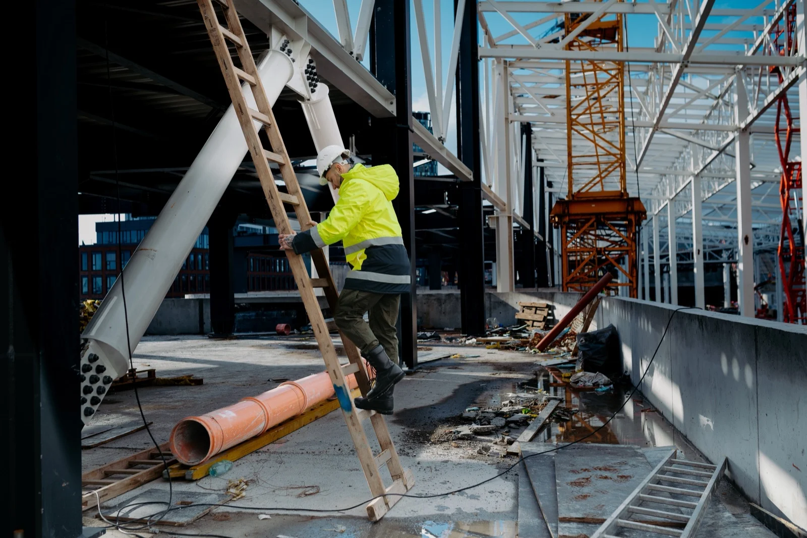 Construction worker on ladder, safety awareness