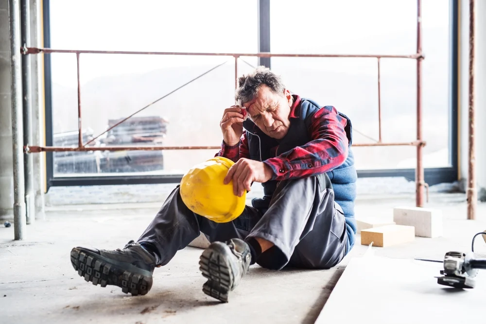 Injured construction worker heals wound after accident.