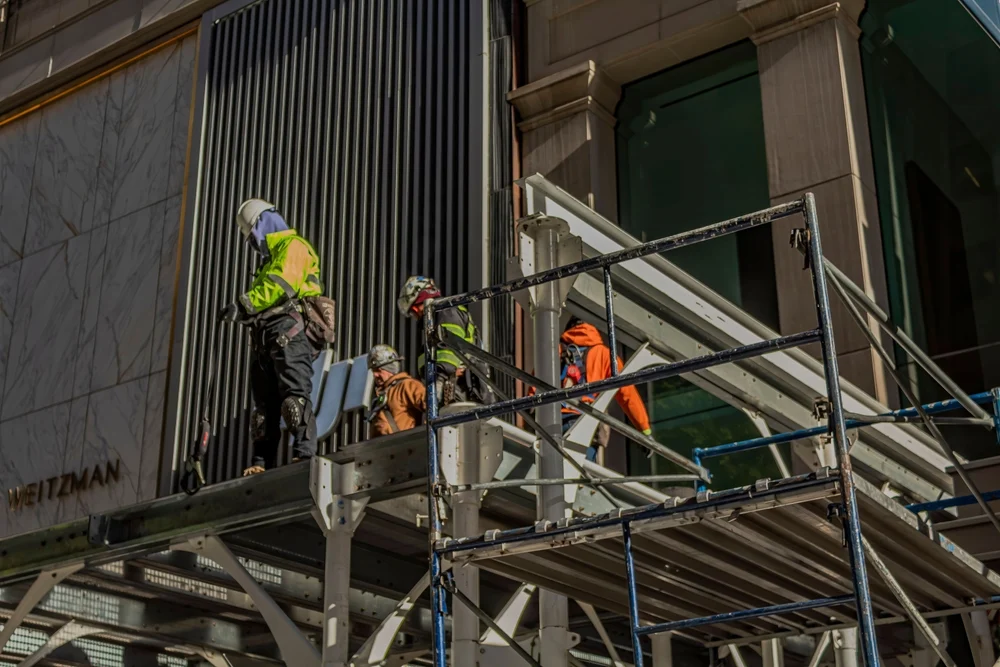 Construction workers work on scaffolding in NYC.