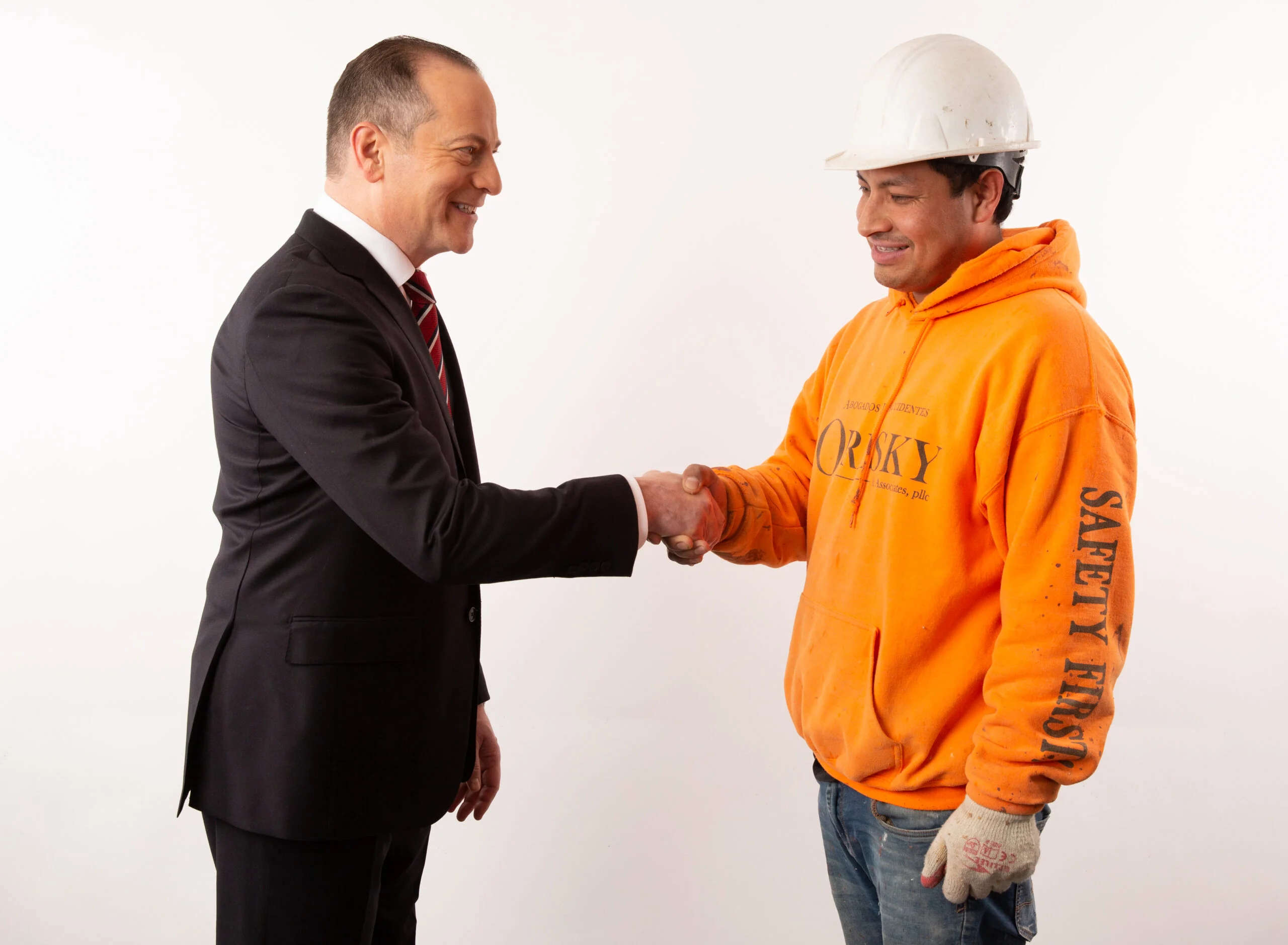 Jacob Oresky, construction accident lawyer, shakes hands with a construction worker