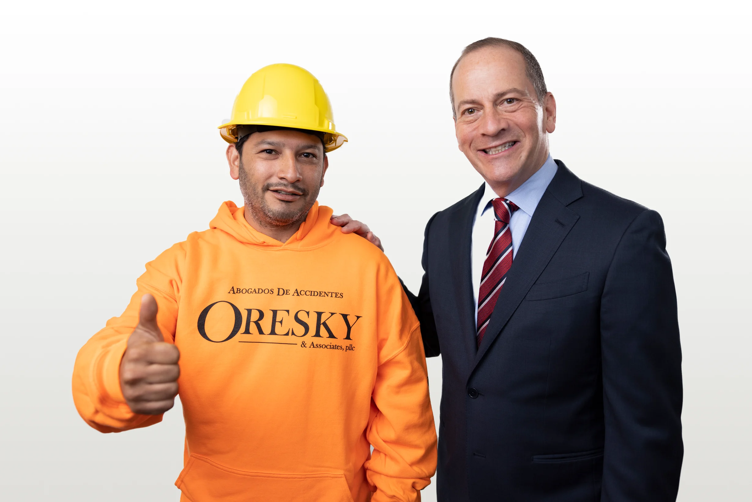 Jacob Oresky, construction accident lawyer in the Bronx, poses with construction worker