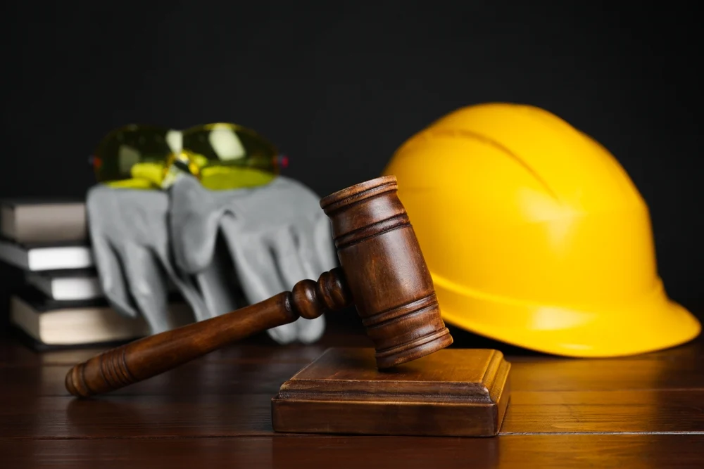 Workers compensation concept, construction protection equipment and judge gavel